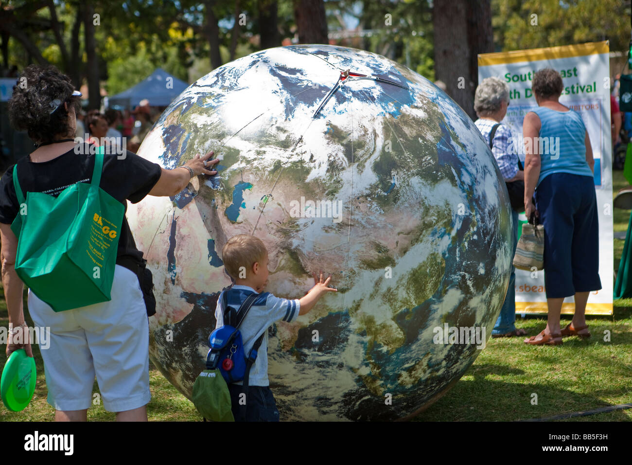 child playing with inflated world globe Earth Day Celebration Santa Barbara California United States of America Stock Photo