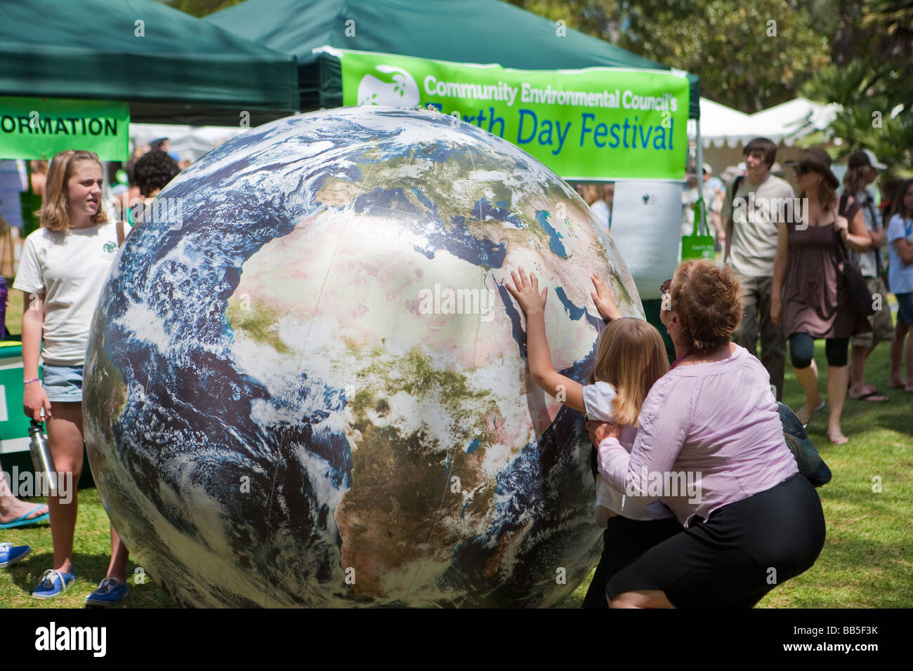 child playing with inflated world globe Earth Day Celebration Santa