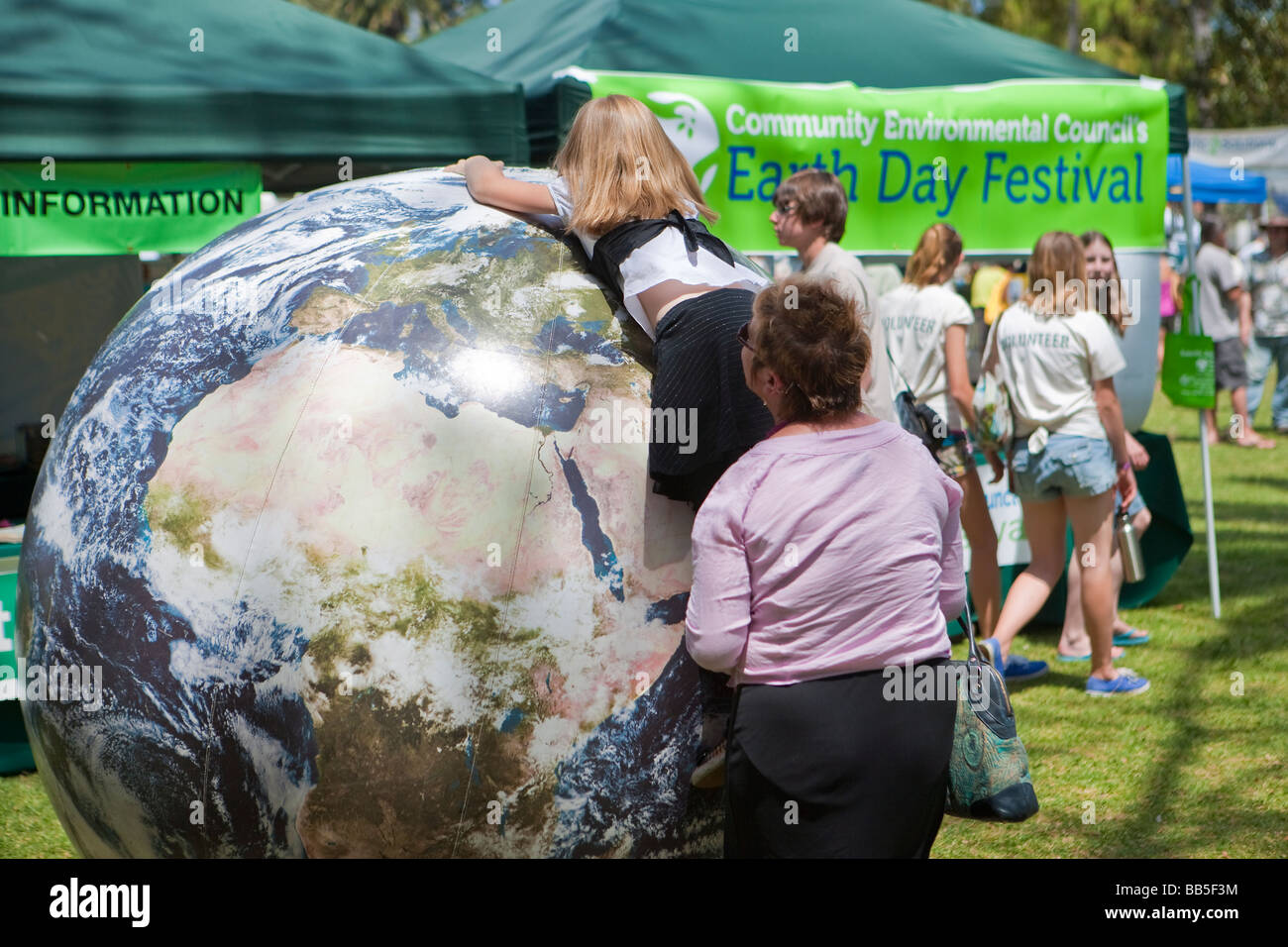 child playing with inflated world globe Earth Day Celebration Santa Barbara California United States of America Stock Photo