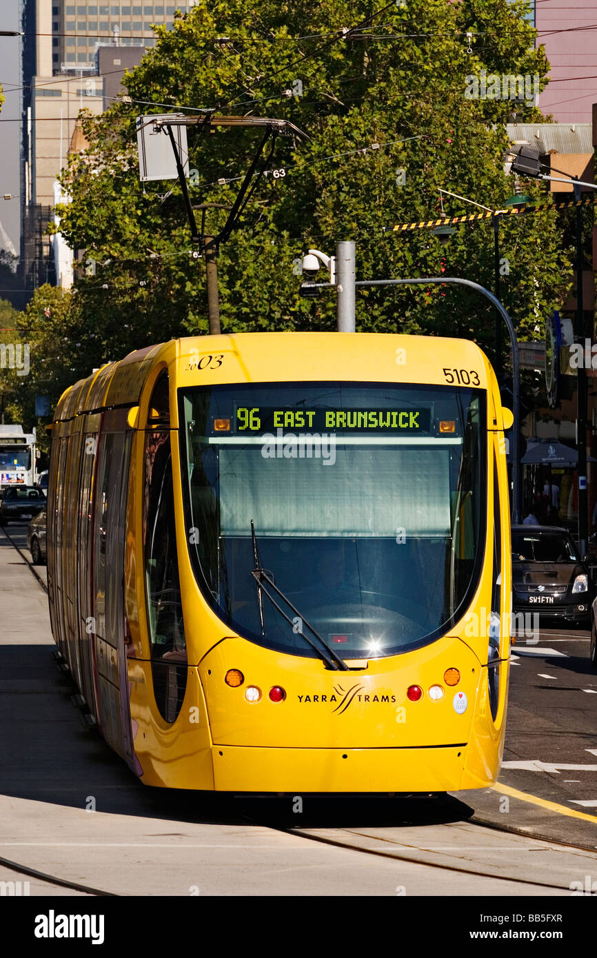 Melbourne Australia  /  A Melbourne  tram travels along a city street in Melbourne Victoria Australia Stock Photo