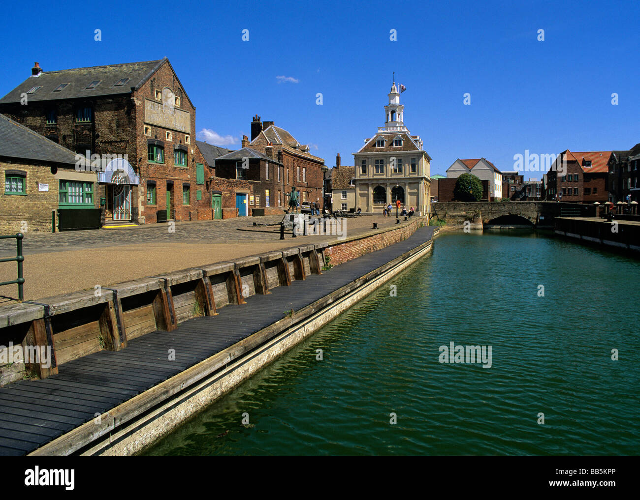 refurbished wet dock and quayside towards the Old Customs house and old warehouses of Kings Lynn on the West Norfolk Coast Stock Photo