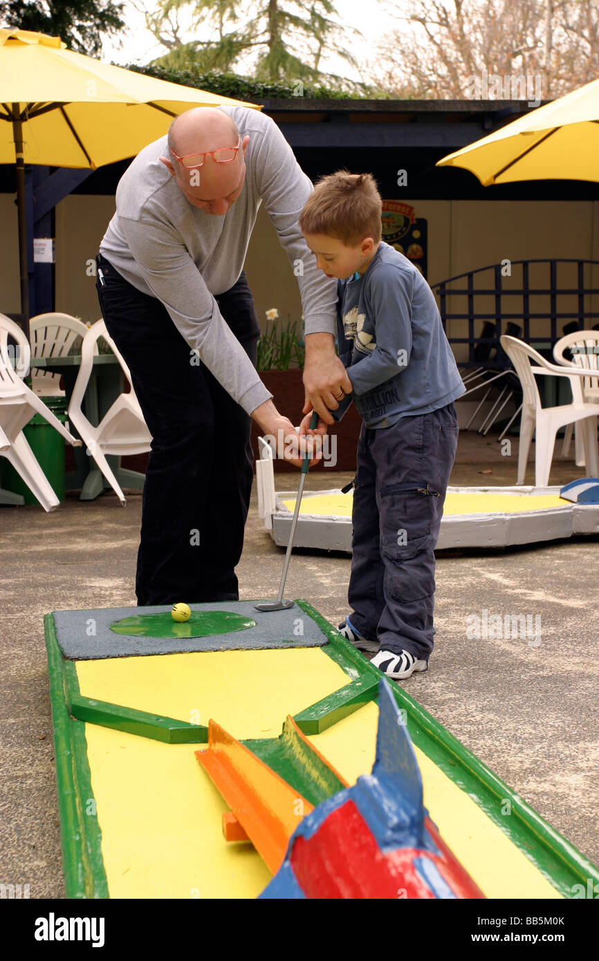 Father and son playing mini golf Stock Photo Alamy