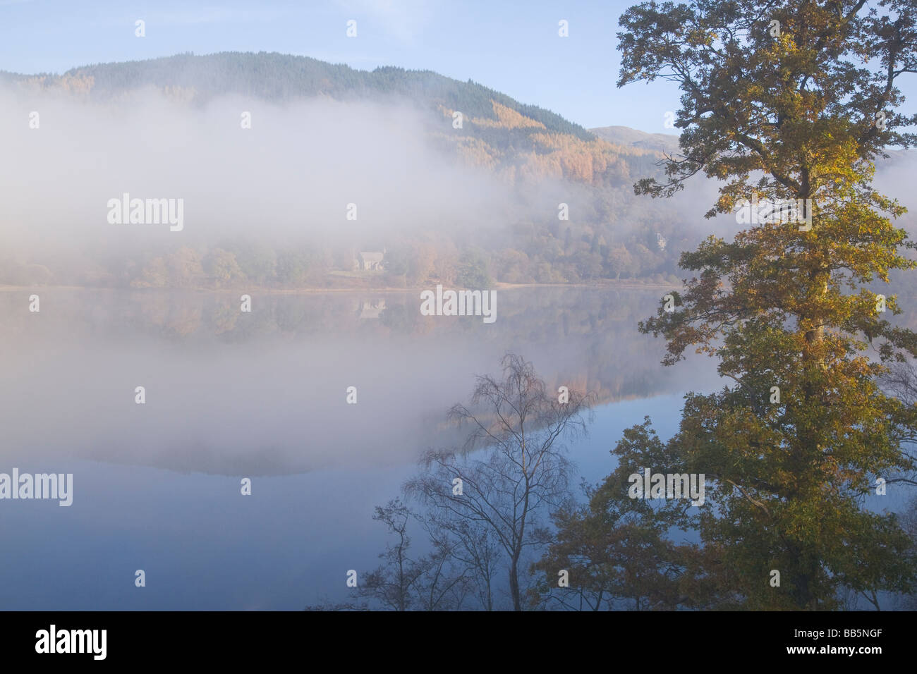 Autumn colours in the Trossachs misty Loch Achray Perthshire Scotland November 2008 Stock Photo