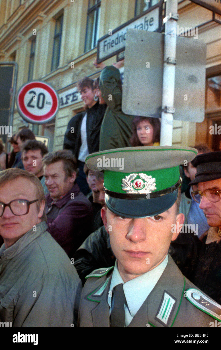 NVA soldier and civilians at the border crossing Checkpoint Charlie in 1989, Berlin, Germany Stock Photo