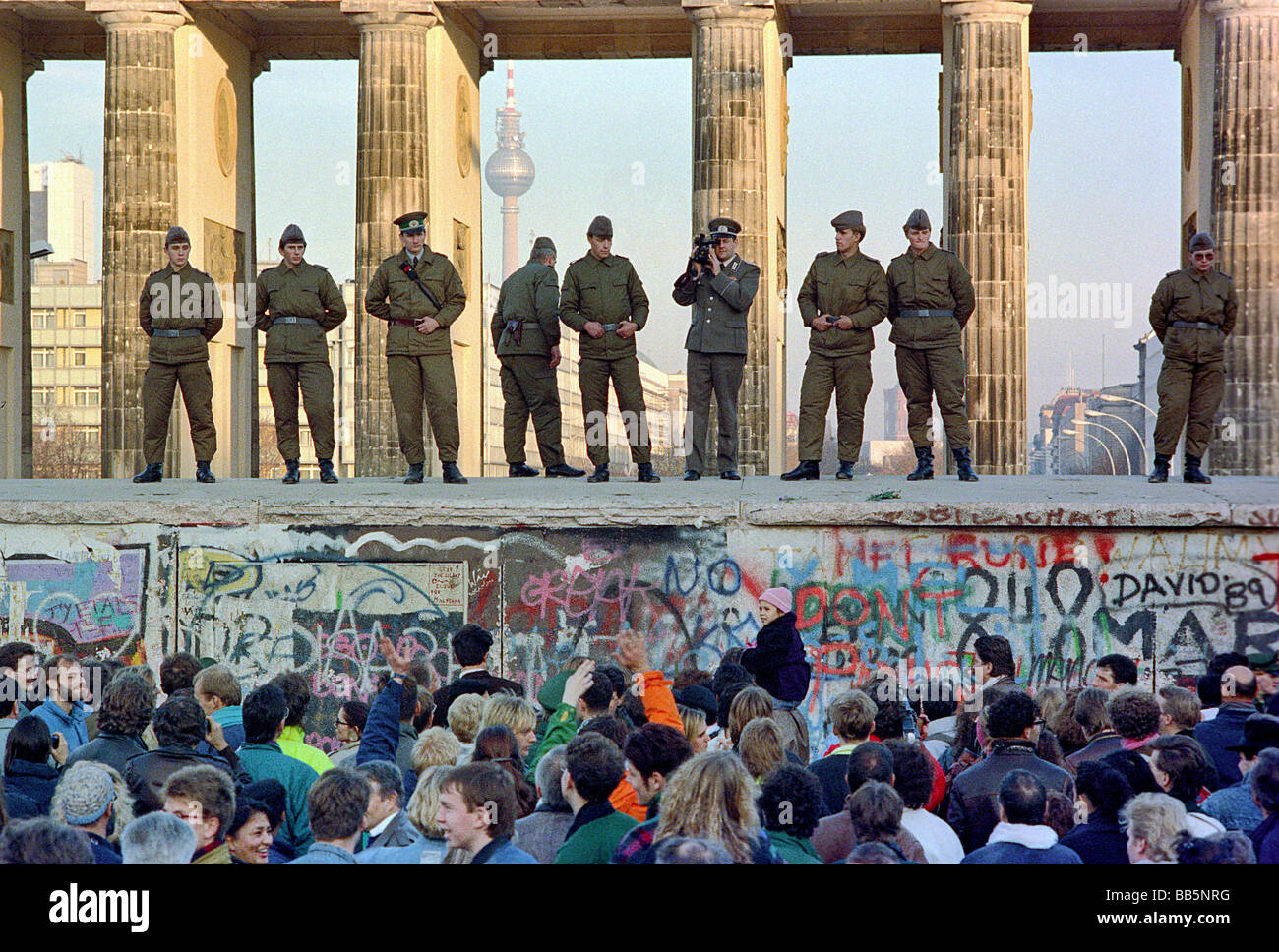 Crowds in front of Berlin Wall and Brandenburg Gate in 1989, Berlin, Germany Stock Photo