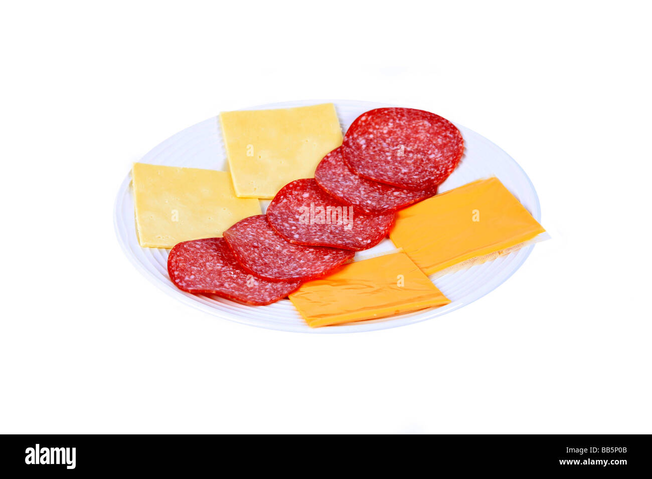 A lunchtime snack of slices of cheddar and processed cheese and German