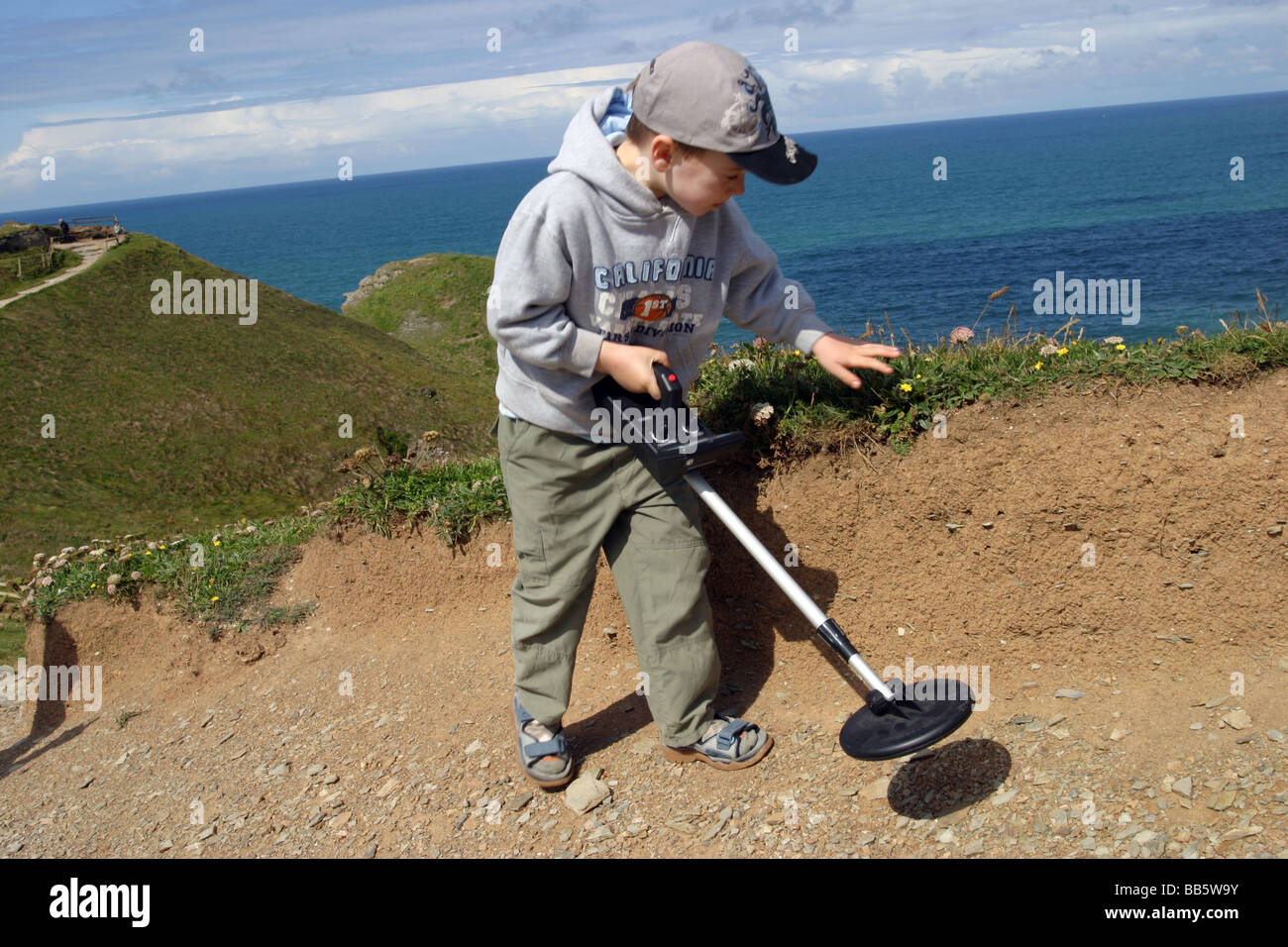 young boy using a metal detector, Cornwall Stock Photo Alamy