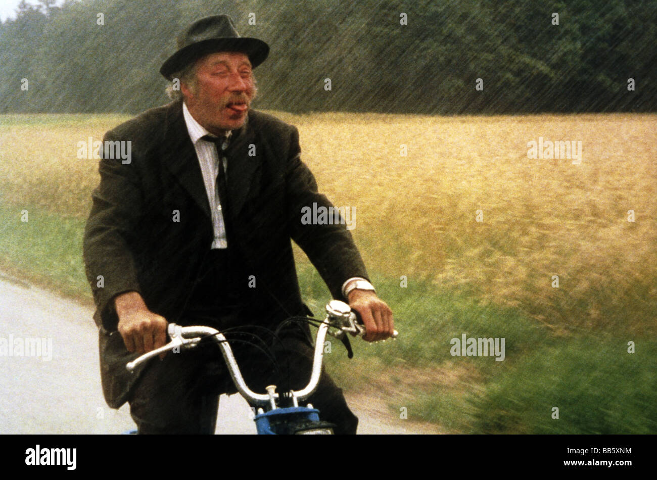 movie, 'Les Petites fugues', FRA/CHE 1979, director: Yves Yersin, scene with: Michel Robin, motor scooter, half length, rain, we Stock Photo