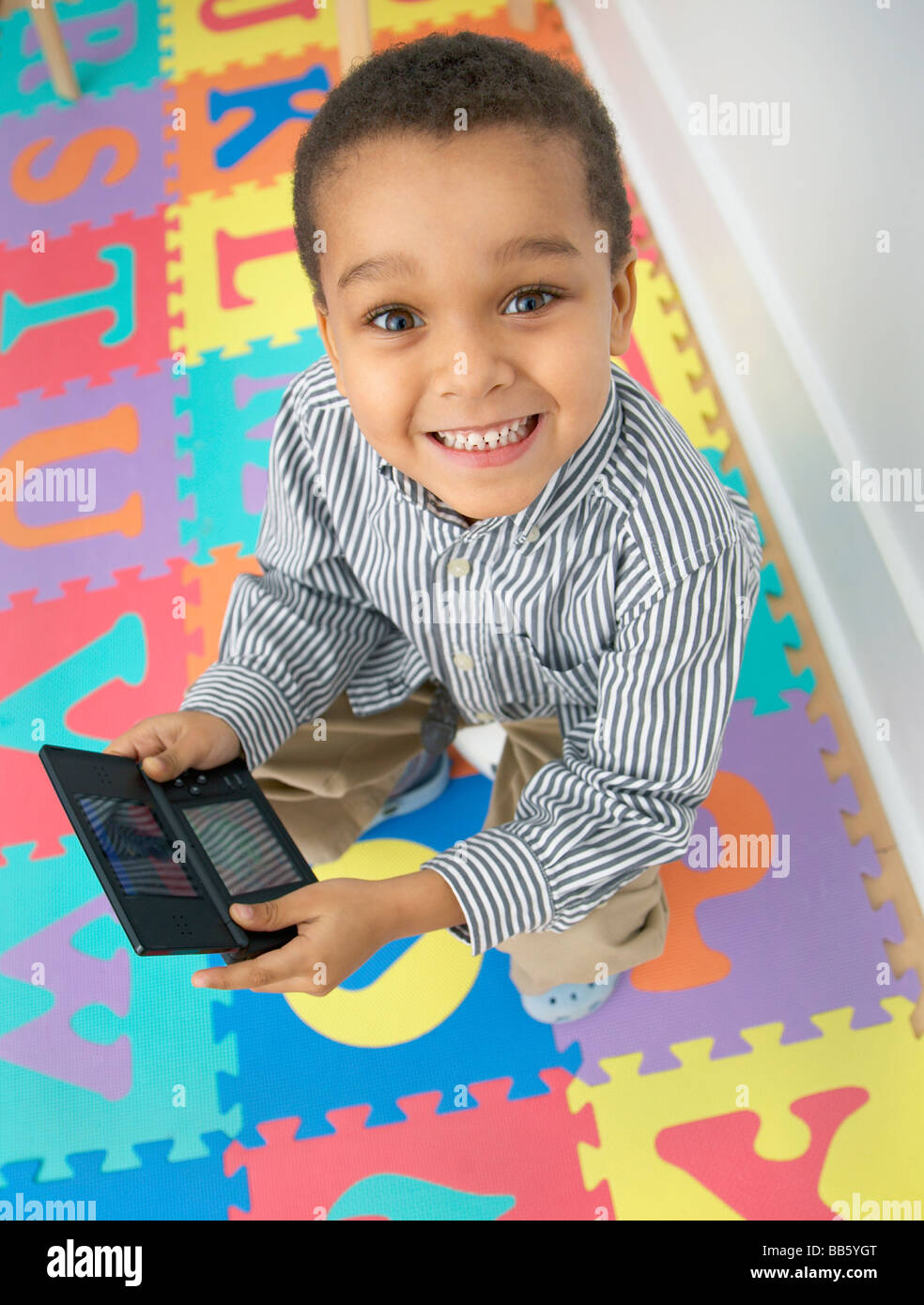 Mixed race boy playing video game Stock Photo Alamy