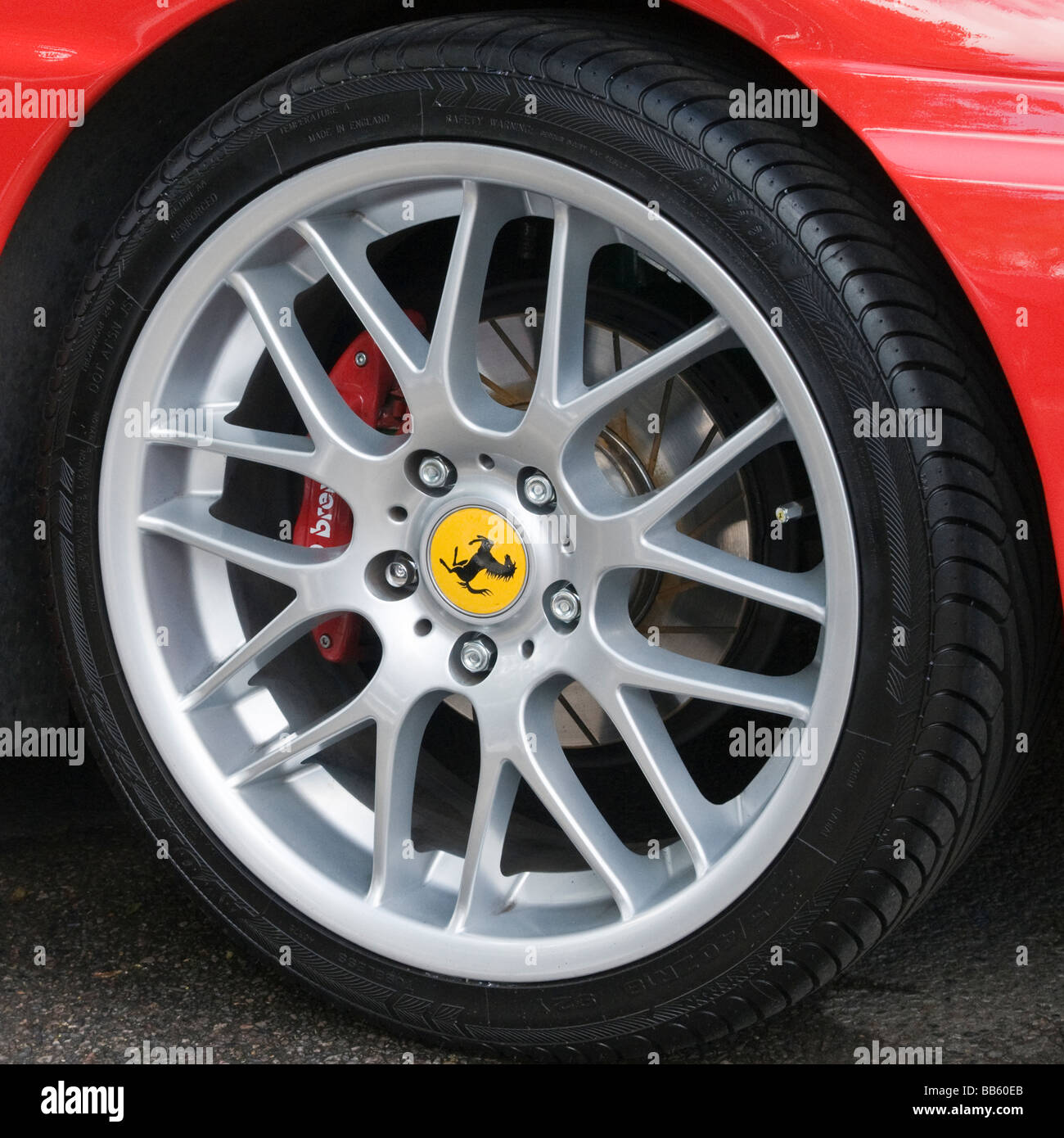 Classic car ferrari alloy wheel, car in red View from the side. Close up (macro) Stock Photo