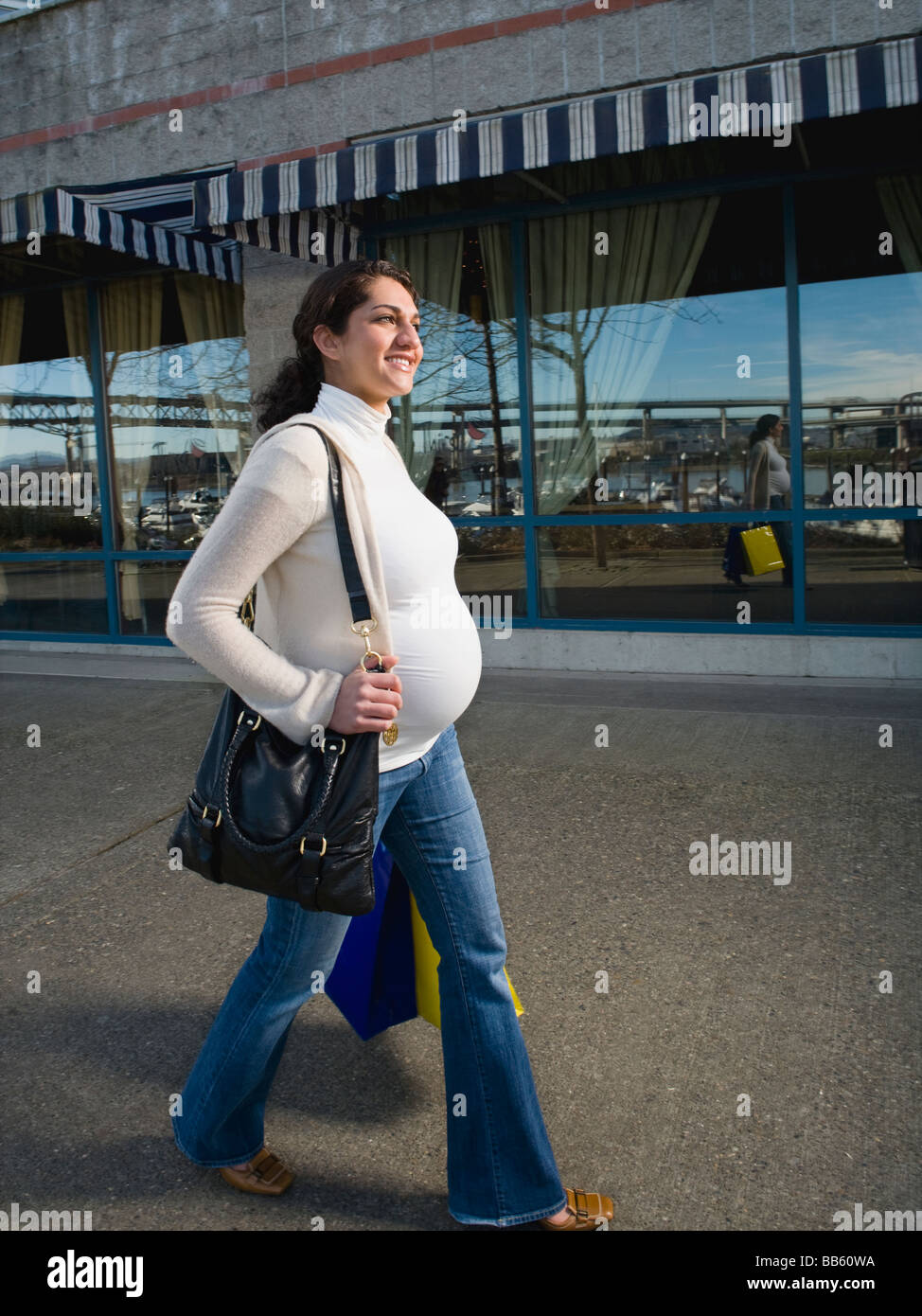 Pregnant Middle Eastern woman carrying shopping bags Stock Photo Alamy