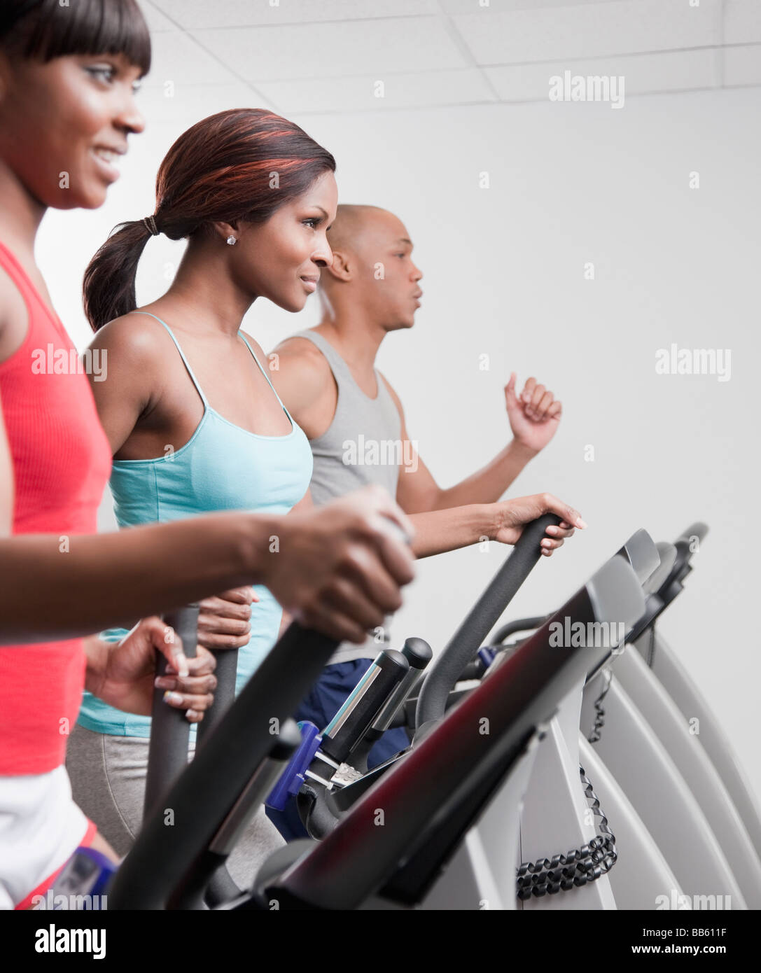 African people using exercise equipment in health club Stock Photo