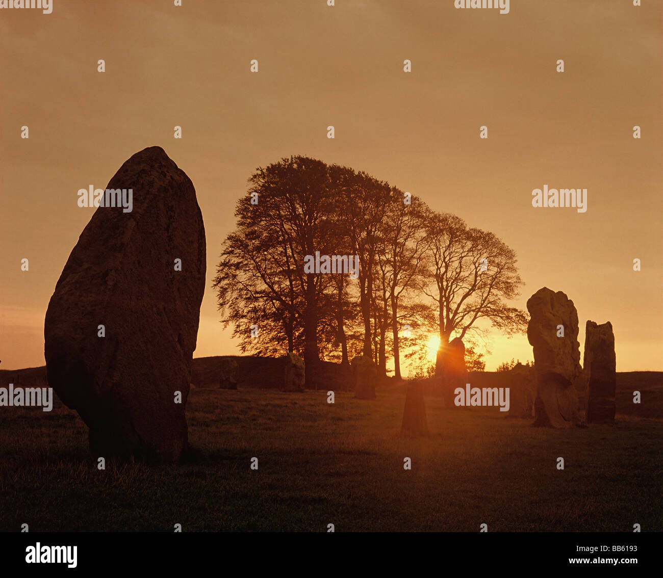 Avebury Standing Stones, Wiltshire England. The sun rises at dawnover Avebury, a Neolithic henge monument.  HOMER SYKES Stock Photo