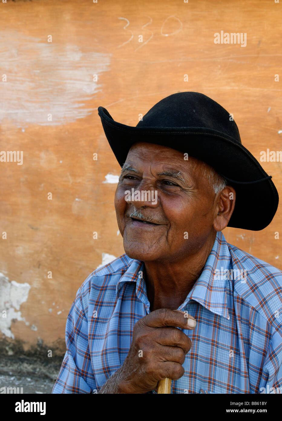 Old Cuban man with walking stick, Trinidad, Cuba Stock Photo