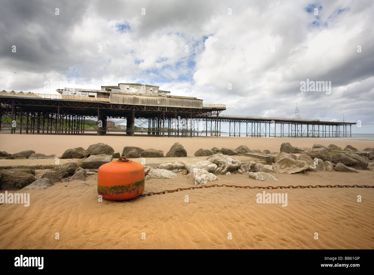 An orange buoy on the beach by the victoria pier colwyn bay Stock Photo
