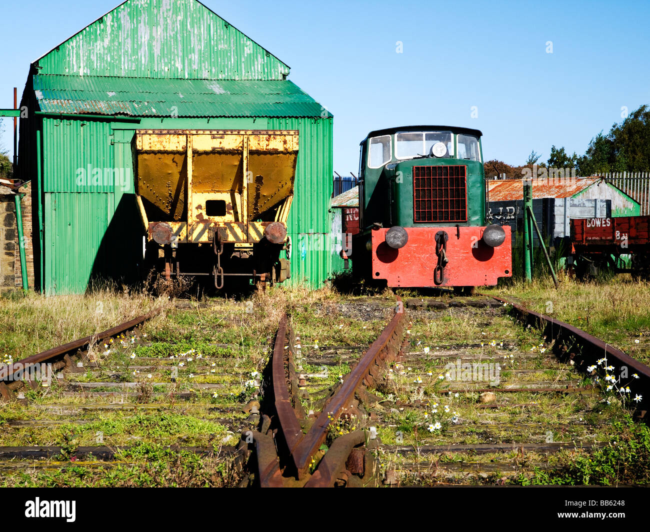 Shed, rolling stock and an engine in railway yard Stock Photo