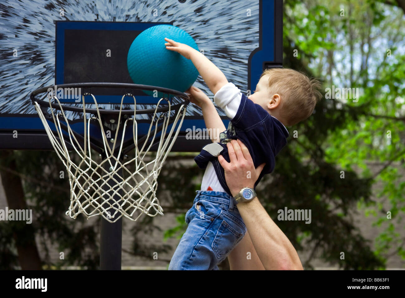 adult-helping-boy-score-a-basketball-shot-BB63F1.jpg