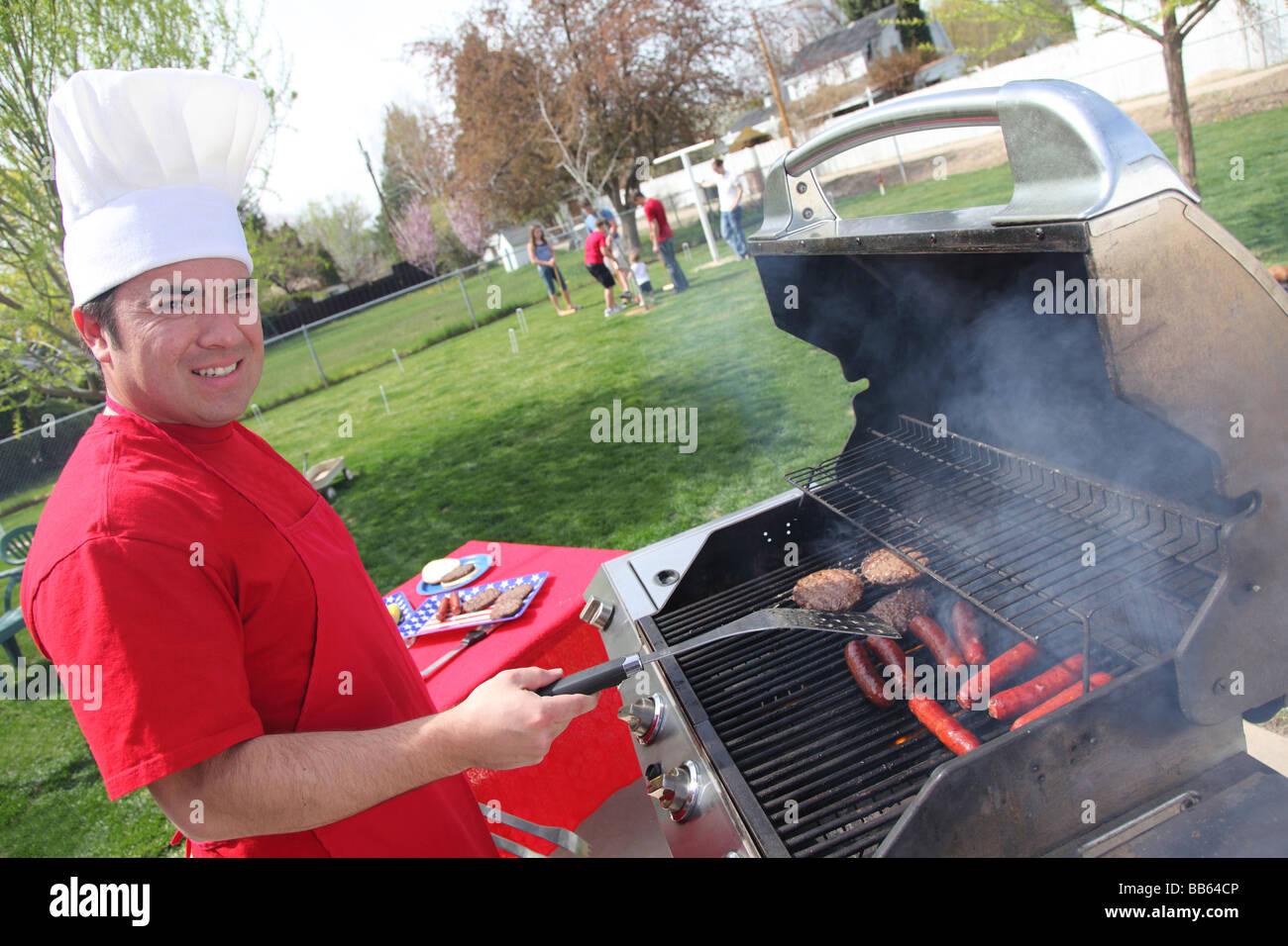 Man cooking at a 4th of July Barbecue Stock Photo