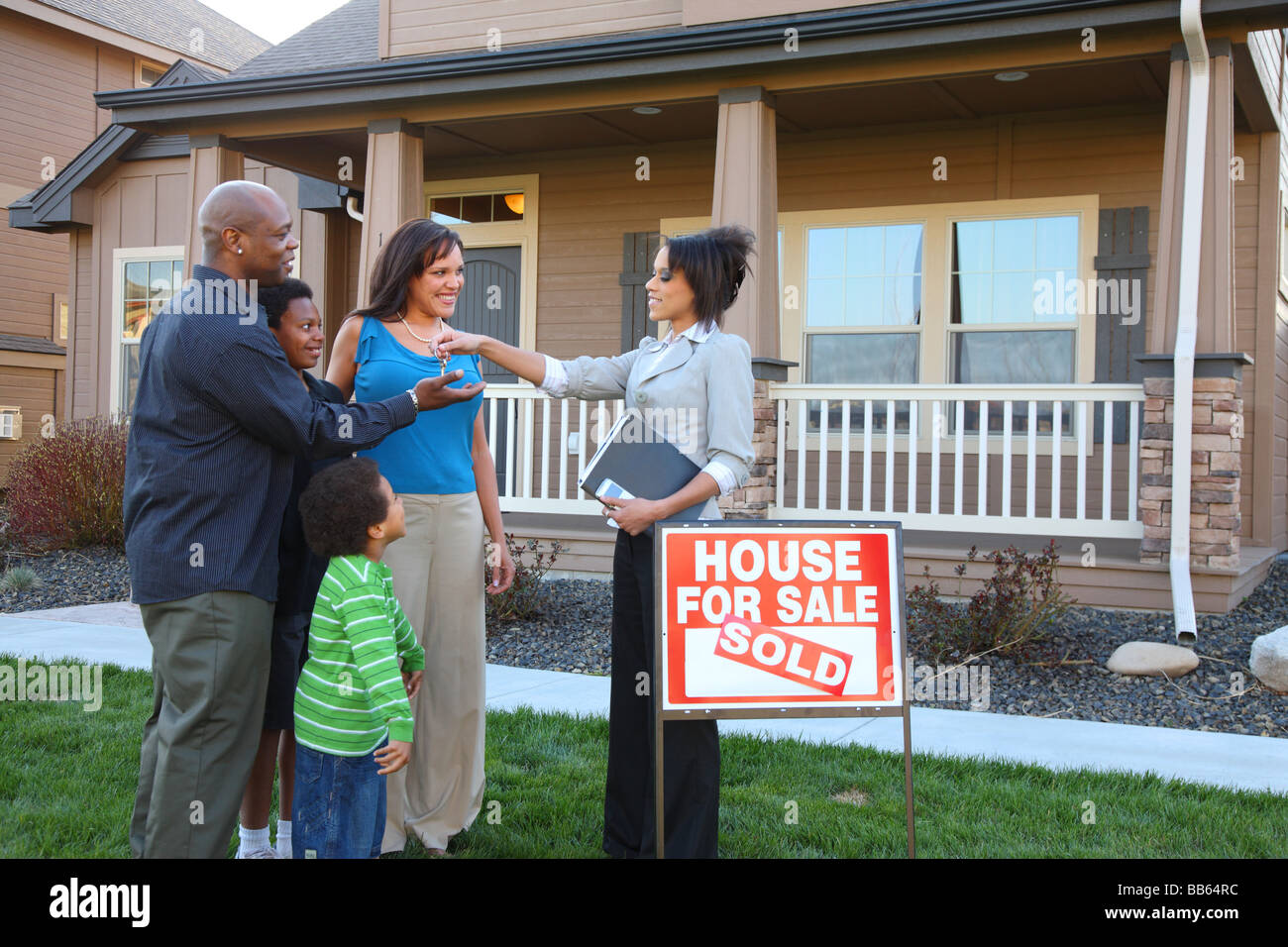 Realtor gives family keys to new home Stock Photo