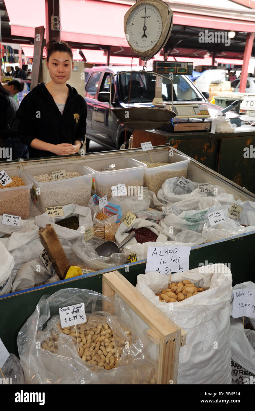 Woman of Chinese origin stall holder selling nuts beans Queen Victoria