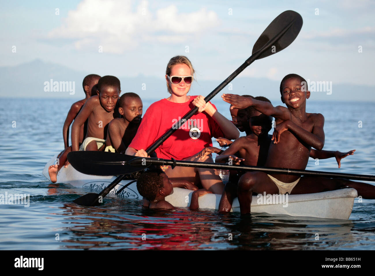 Traveller on a Kayak in Lake Malawi with local children Stock Photo