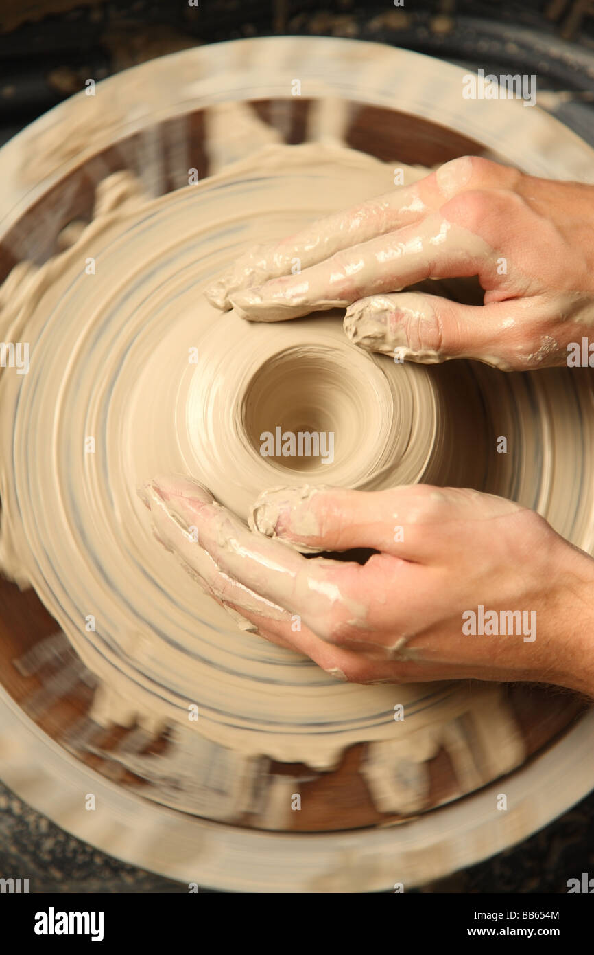 Overhead view of hands shaping pottery Stock Photo