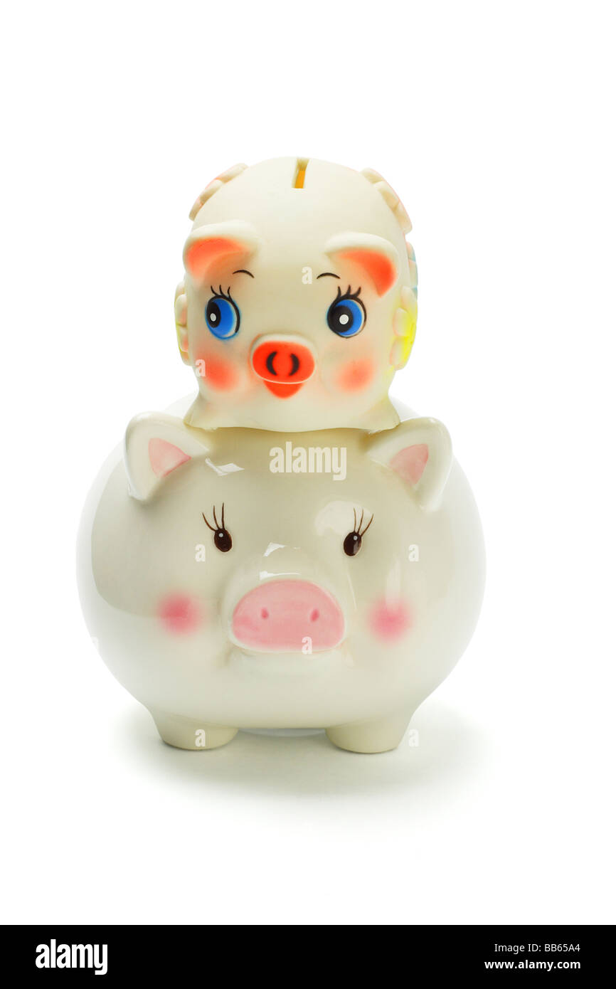 Piggy banks piggyback ride on white background Stock Photo Alamy
