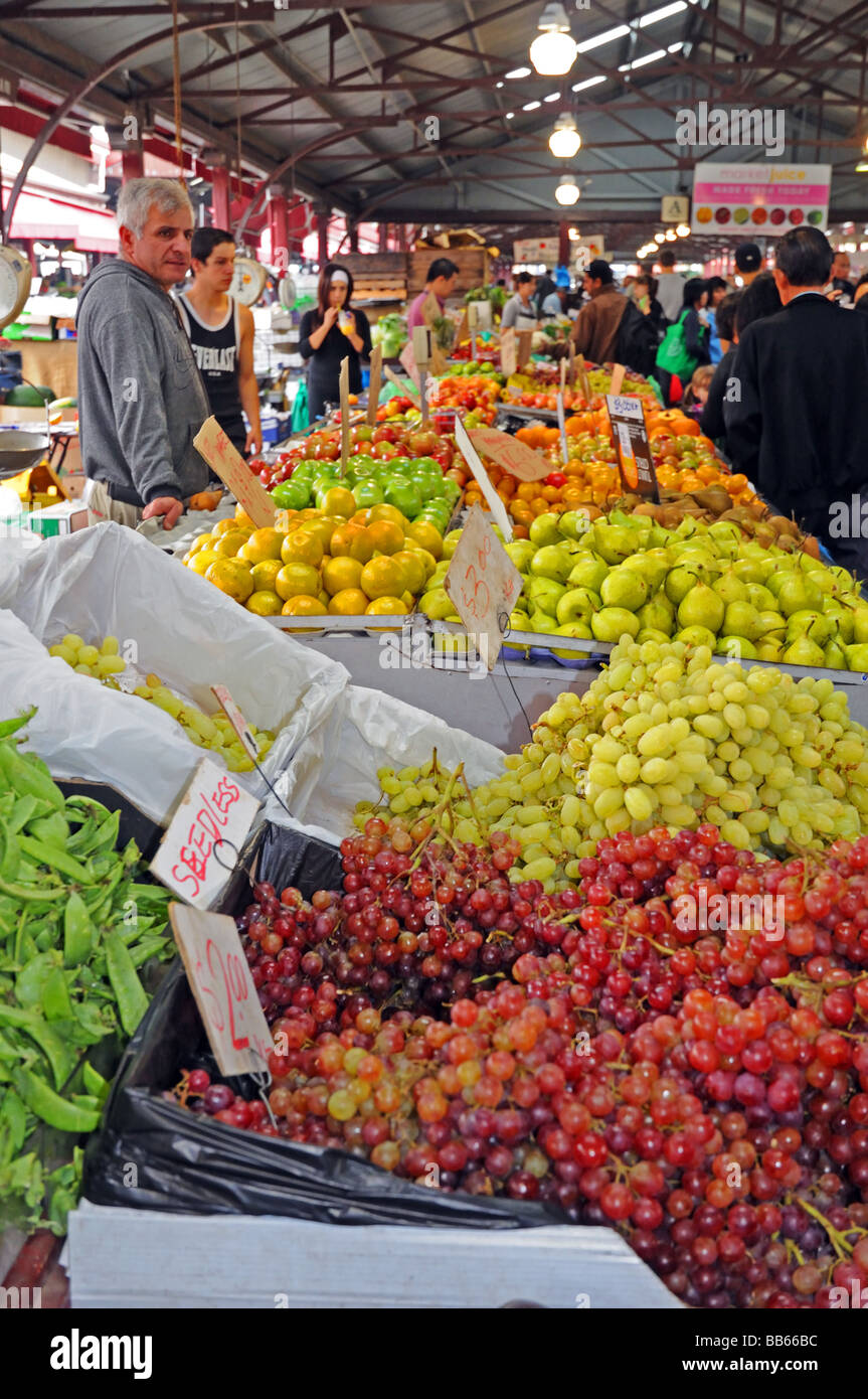 White male stall holder selling fruit and vegetables Queen Victoria