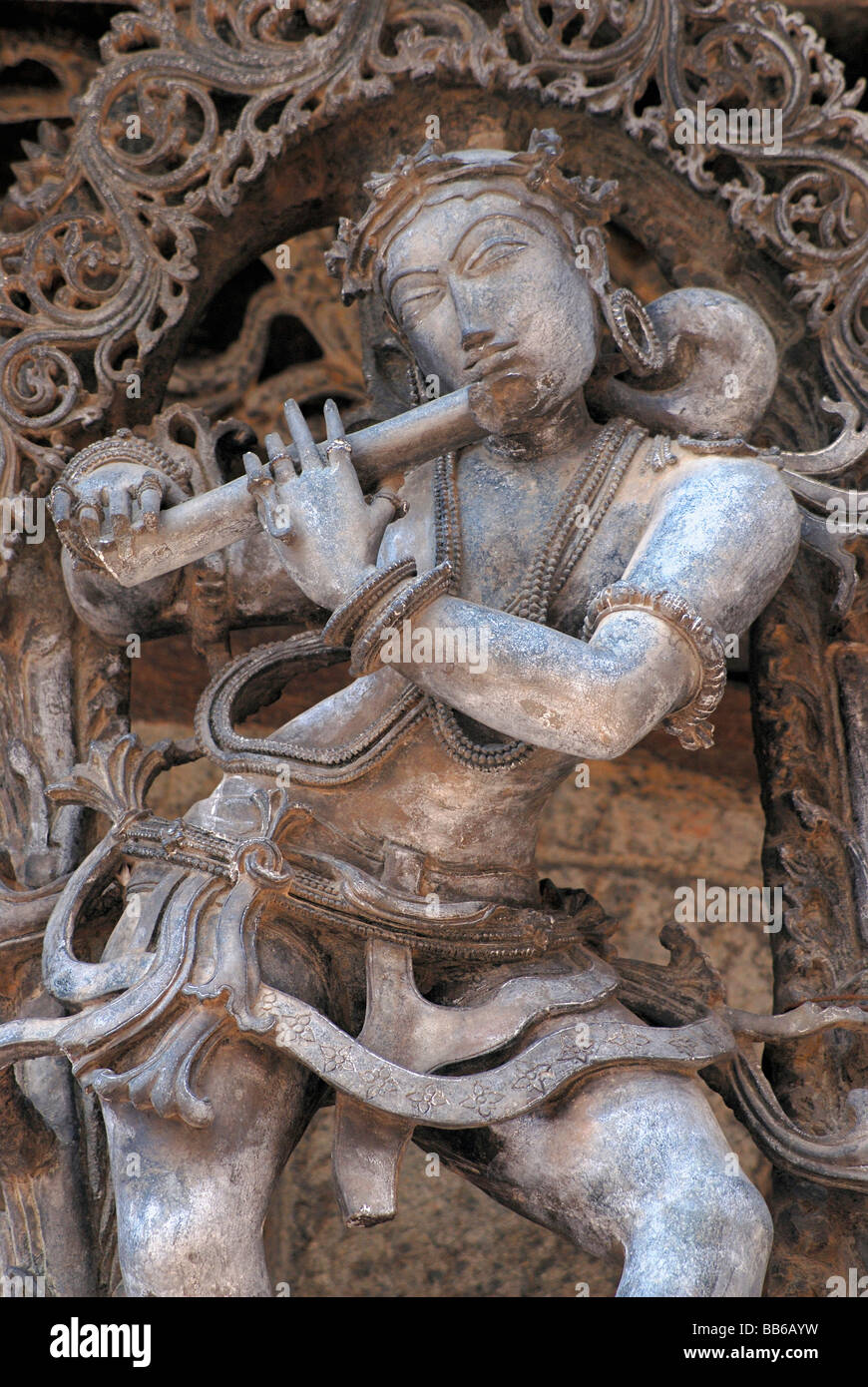 Belur - Karnataka, Channakeshwar temple, showing Krishna playing flute - bracket figure on the South. Stock Photo