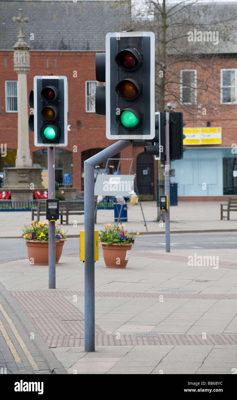 Green traffic lights at a pedestrian crossing in a town in England Stock Photo