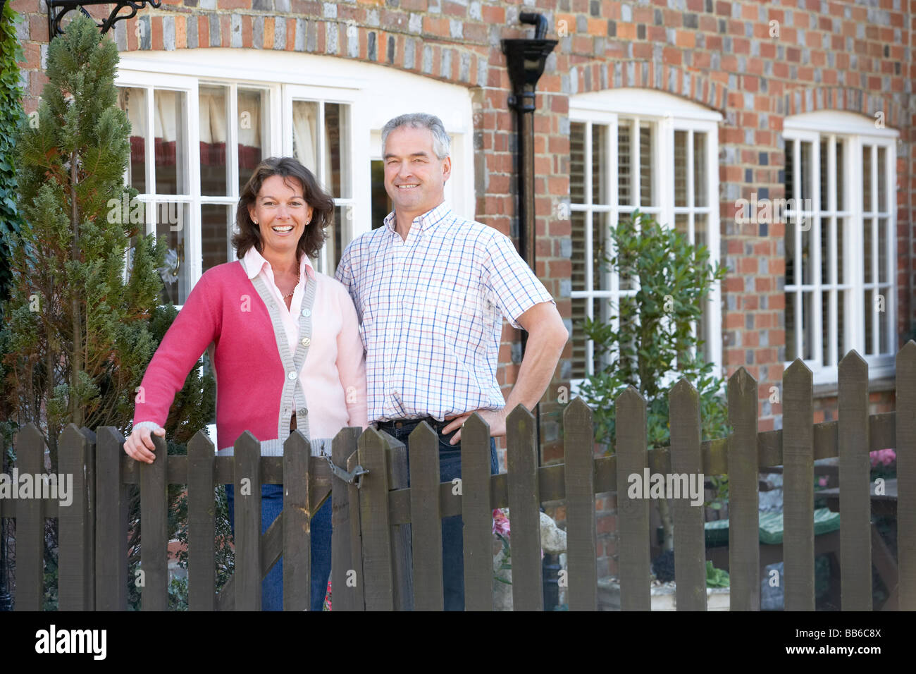 Farmer And Wife Standing In Front Of Farmhouse Stock Photo - Alamy