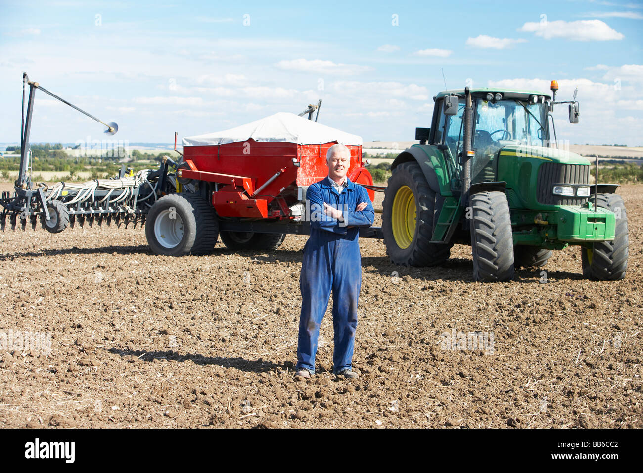 Driver Standing In Front Of Tractor Stock Photo