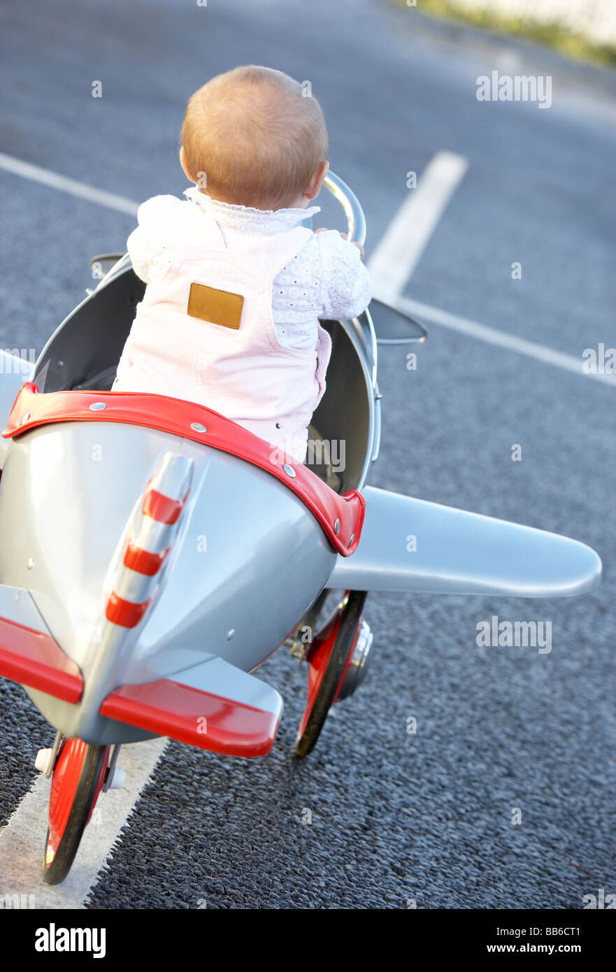 Baby Girl Riding In Toy Aeroplane Stock Photo