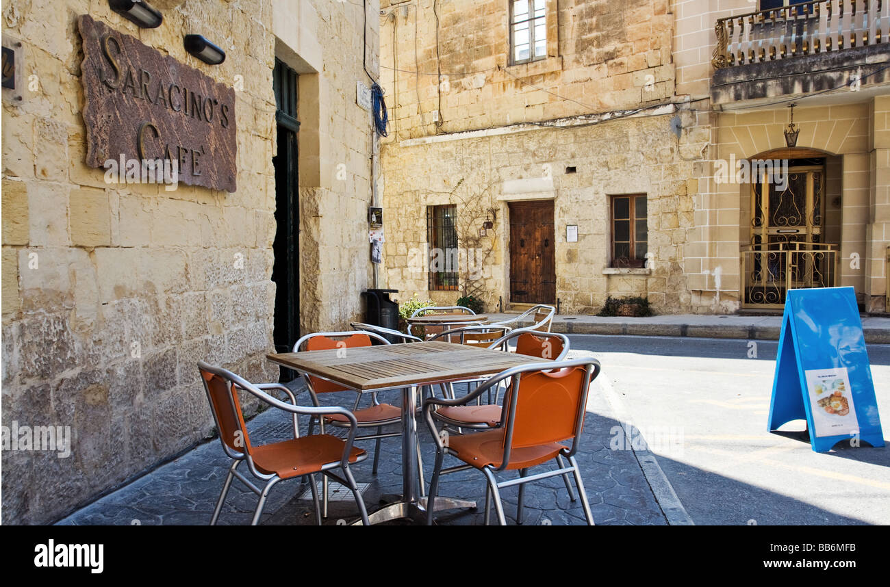 Table and chairs outside Saracino's pizzaria - Attard, Malta. Stock Photo