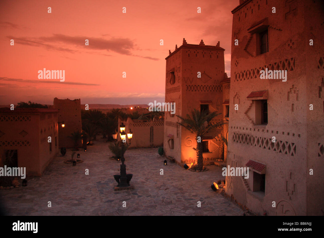 Exterior kasbah style/pise/mud walls of Hotel Kasbah Xalucca Maadid at dusk/evening/sunset, Sahara region, Erfoud,south Morocco Stock Photo