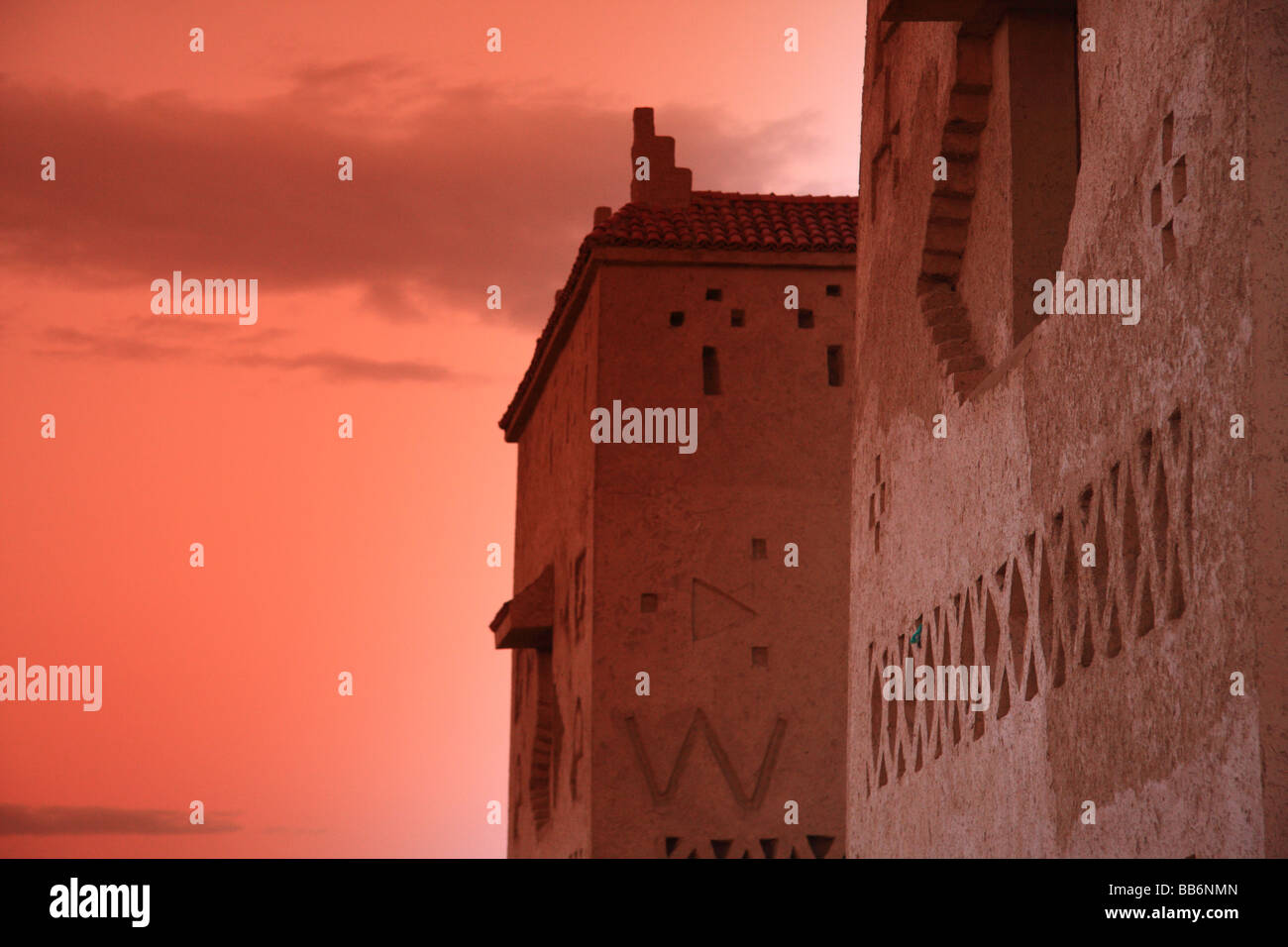 Exterior kasbah style/pise/mud walls of Hotel Kasbah Xalucca Maadid at dusk/evening/sunset, Sahara region, Erfoud,south Morocco Stock Photo