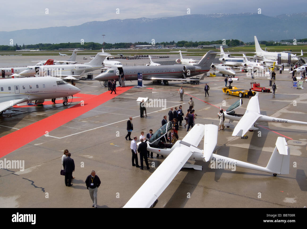 Two Motorised Gliders and Executive Jets at EBACE Trade Show Geneva Airport Switzerland Geneve Suisse Stock Photo
