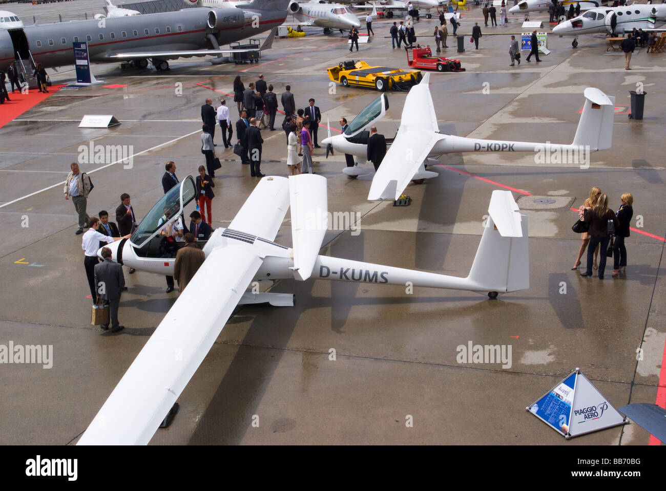 Two Motorised Gliders and Executive Jets at EBACE Trade Show Geneva Airport Switzerland Geneve Suisse Stock Photo