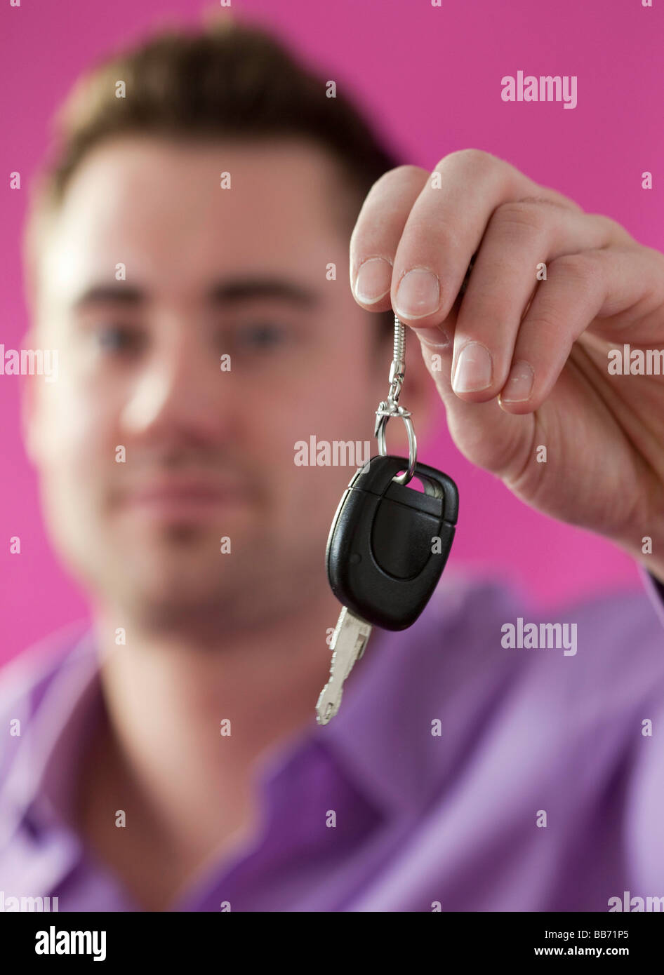 Young man holding a car key Stock Photo