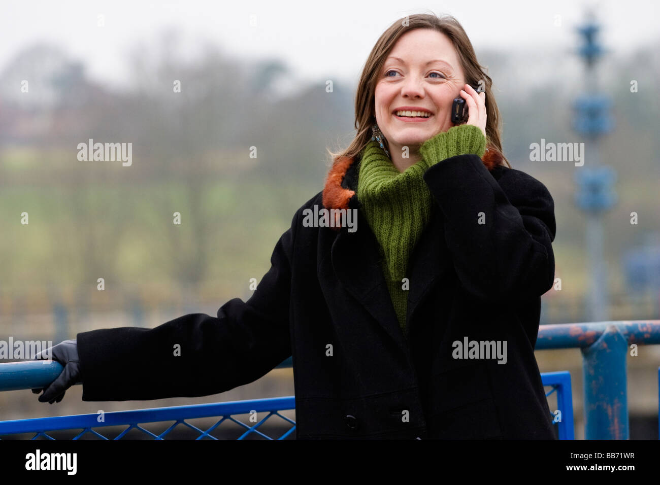 Young woman in her 30's outside on a moblie phone Stock Photo