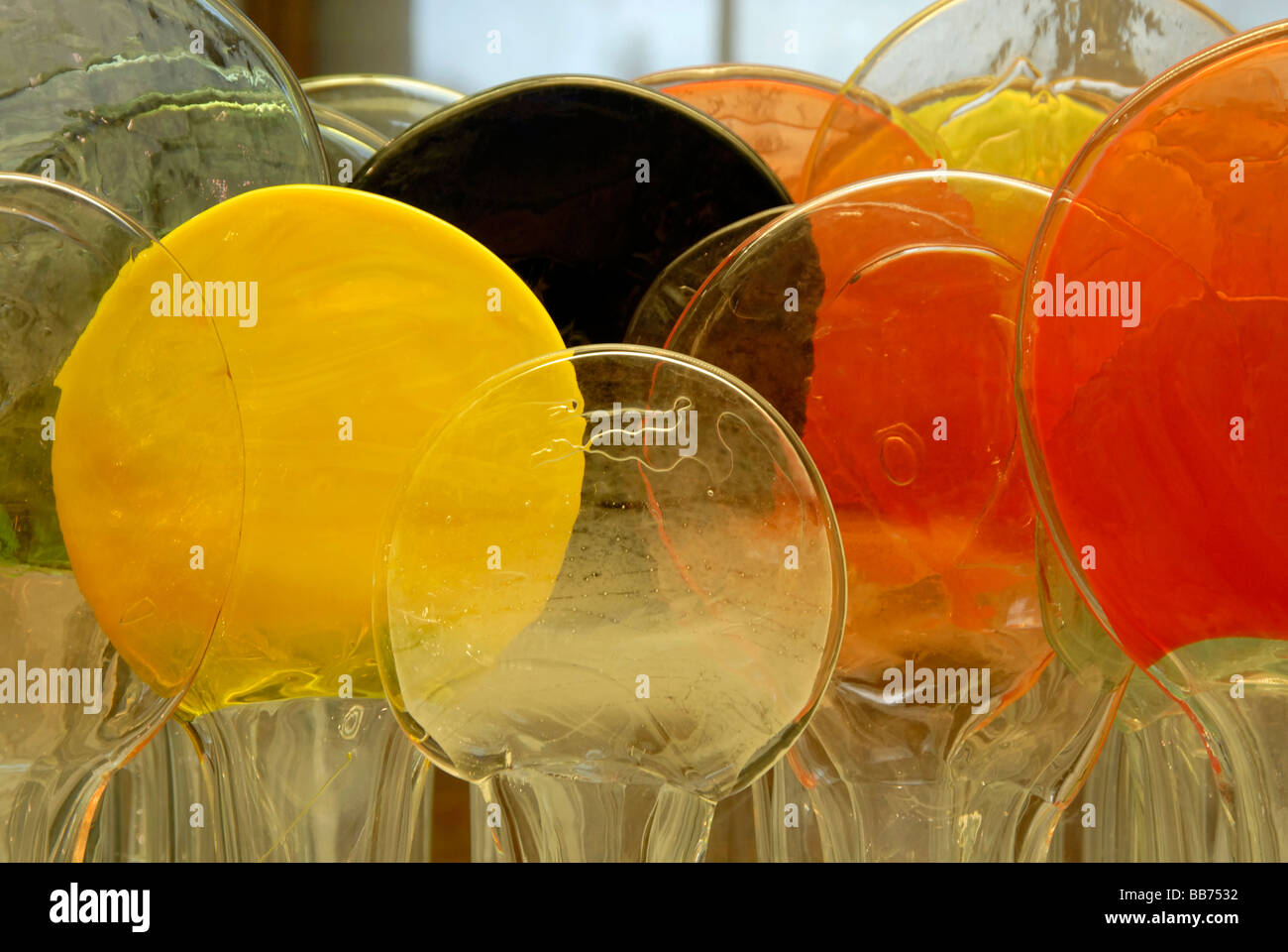 Candy coloured yellow and orange glass discs detail of glass sculpture by Finish artist Oiva Toikka called 'Lollipop Isle' Stock Photo
