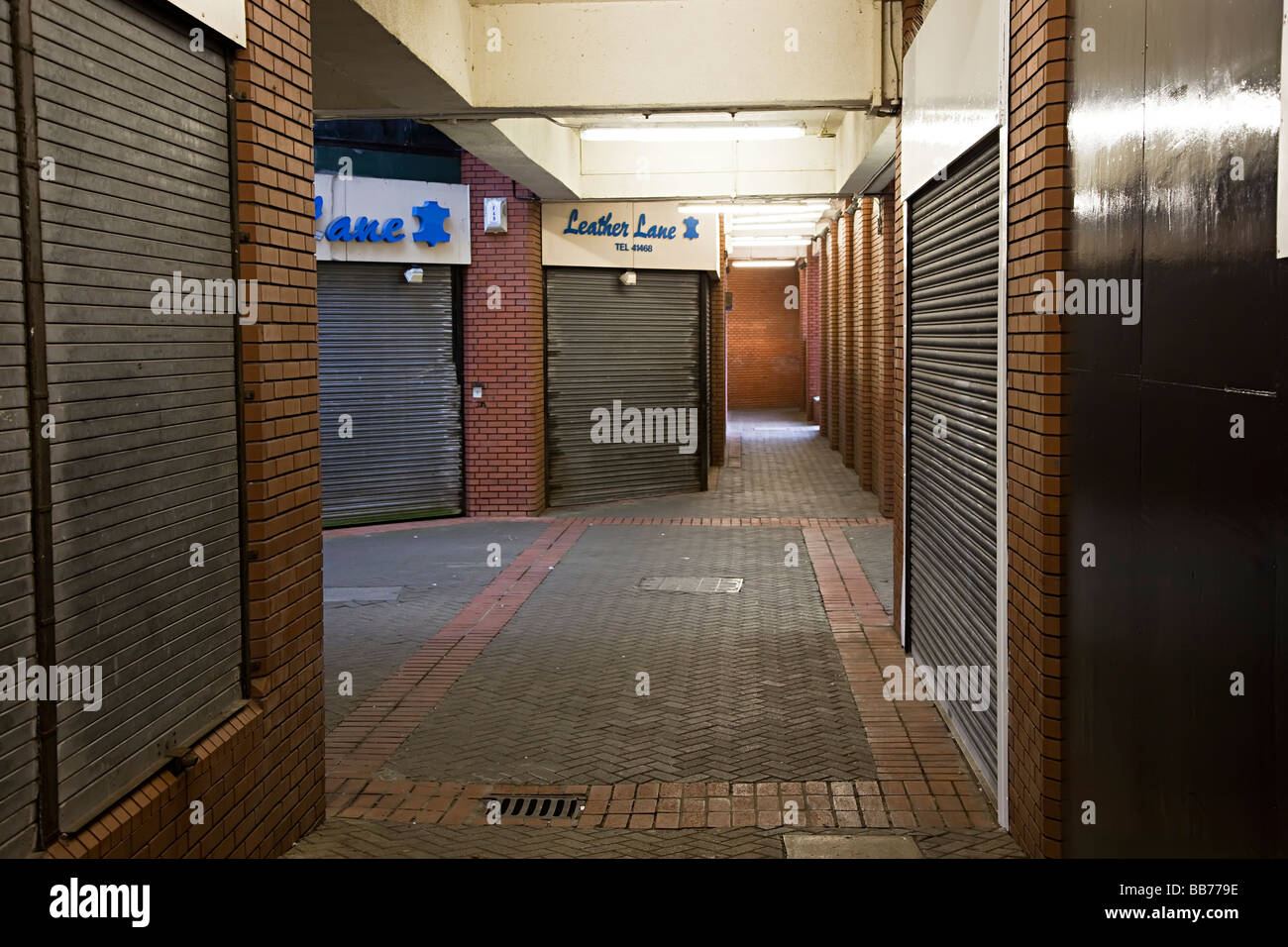Modern shopping complex with closed shops and shuttered windows Swansea Wales UK Stock Photo
