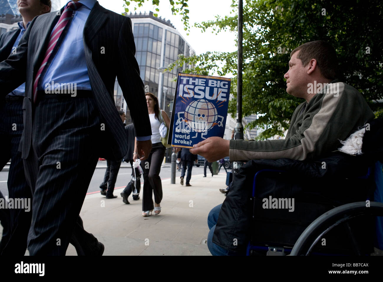 Disabled man selling Big Issue - newspaper for the homeless - in the City of London Stock Photo