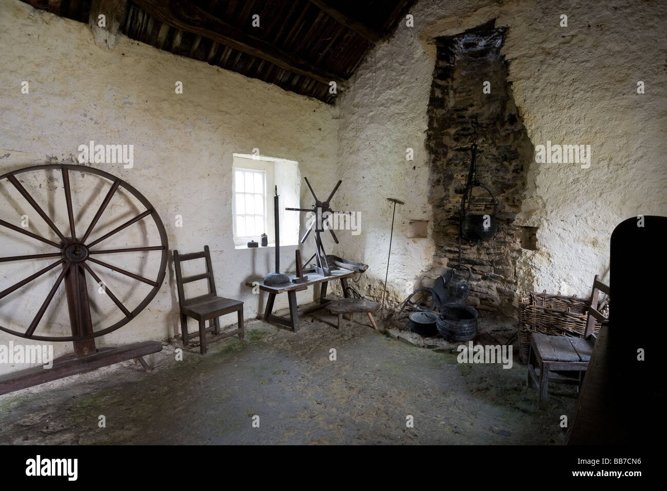 Eighteenth Century Irish Cottage Interior. The interior of a 18th century cottage with spinning wheel and open fireplace Stock Photo