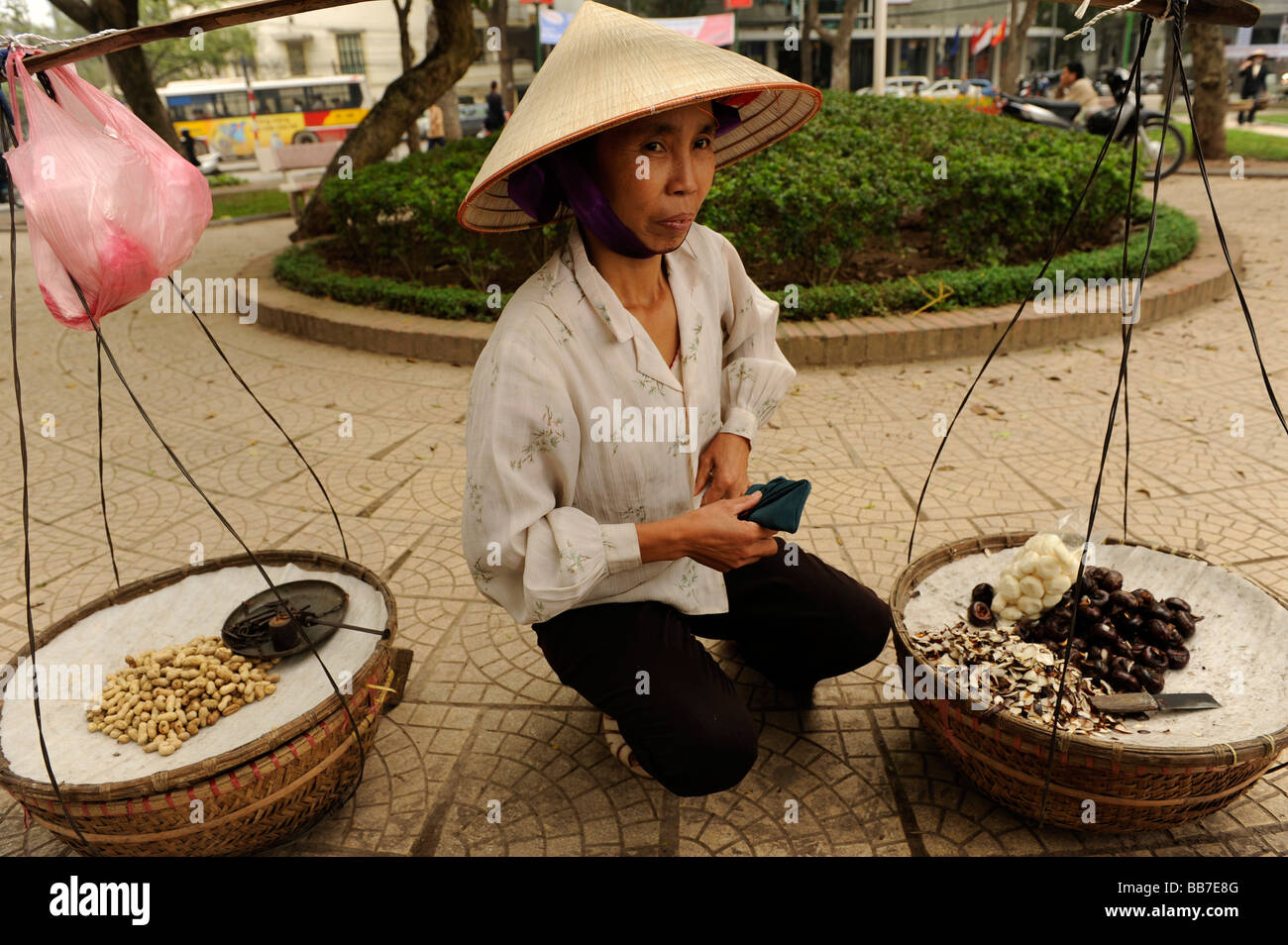 Street hawker selling waternut or matai or chinese water chestnut, old Quarter, Hanoi, Vitenam. Stock Photo