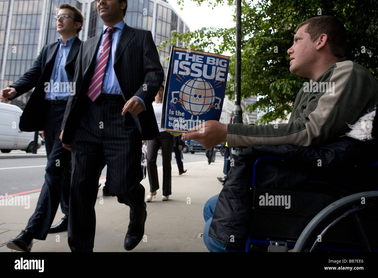 Disabled man selling Big Issue - newspaper for the homeless - in the City of London Stock Photo