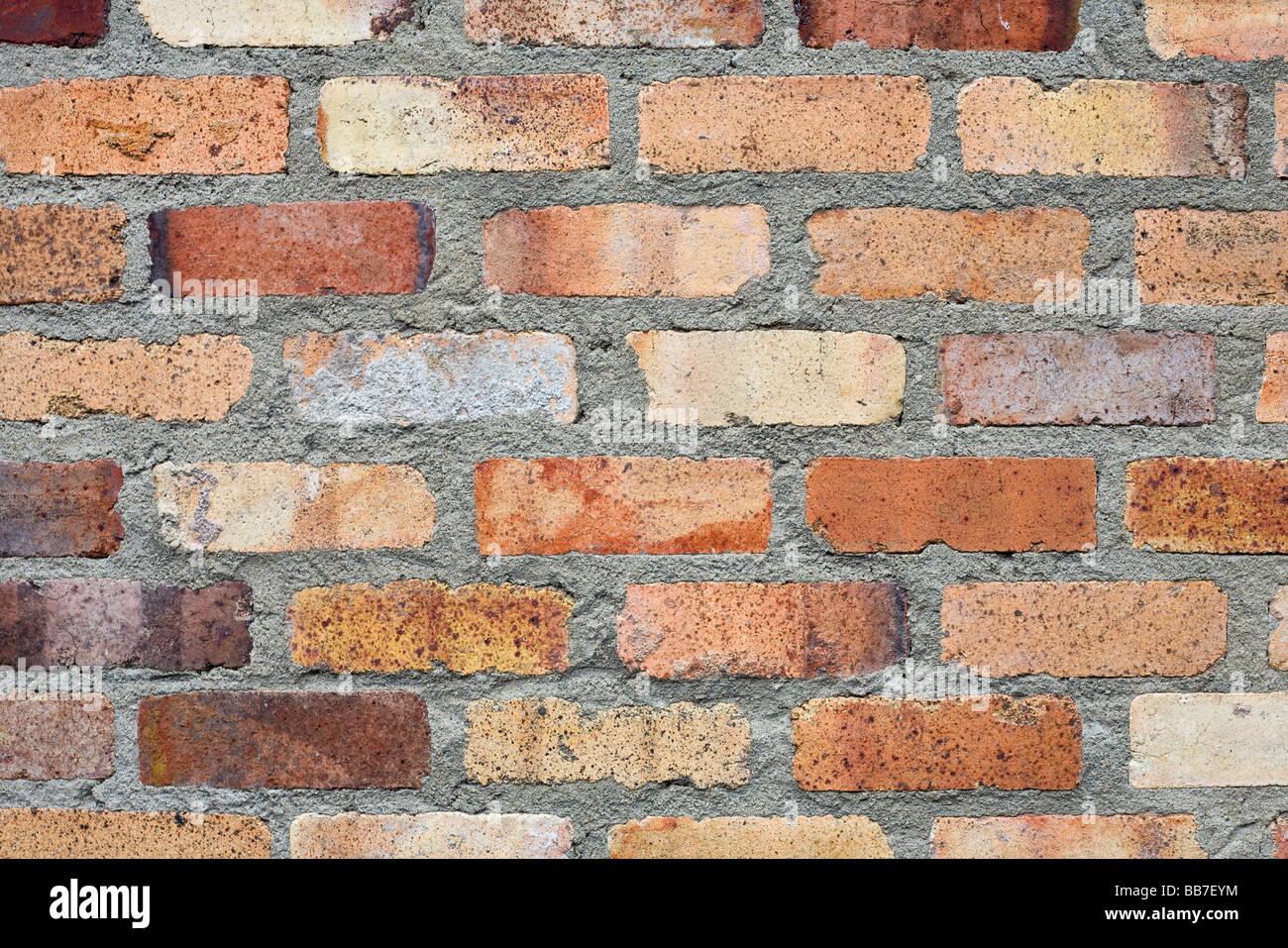 Bricks and Mortar. Orange fired bricks set in thick grey mortar Stock