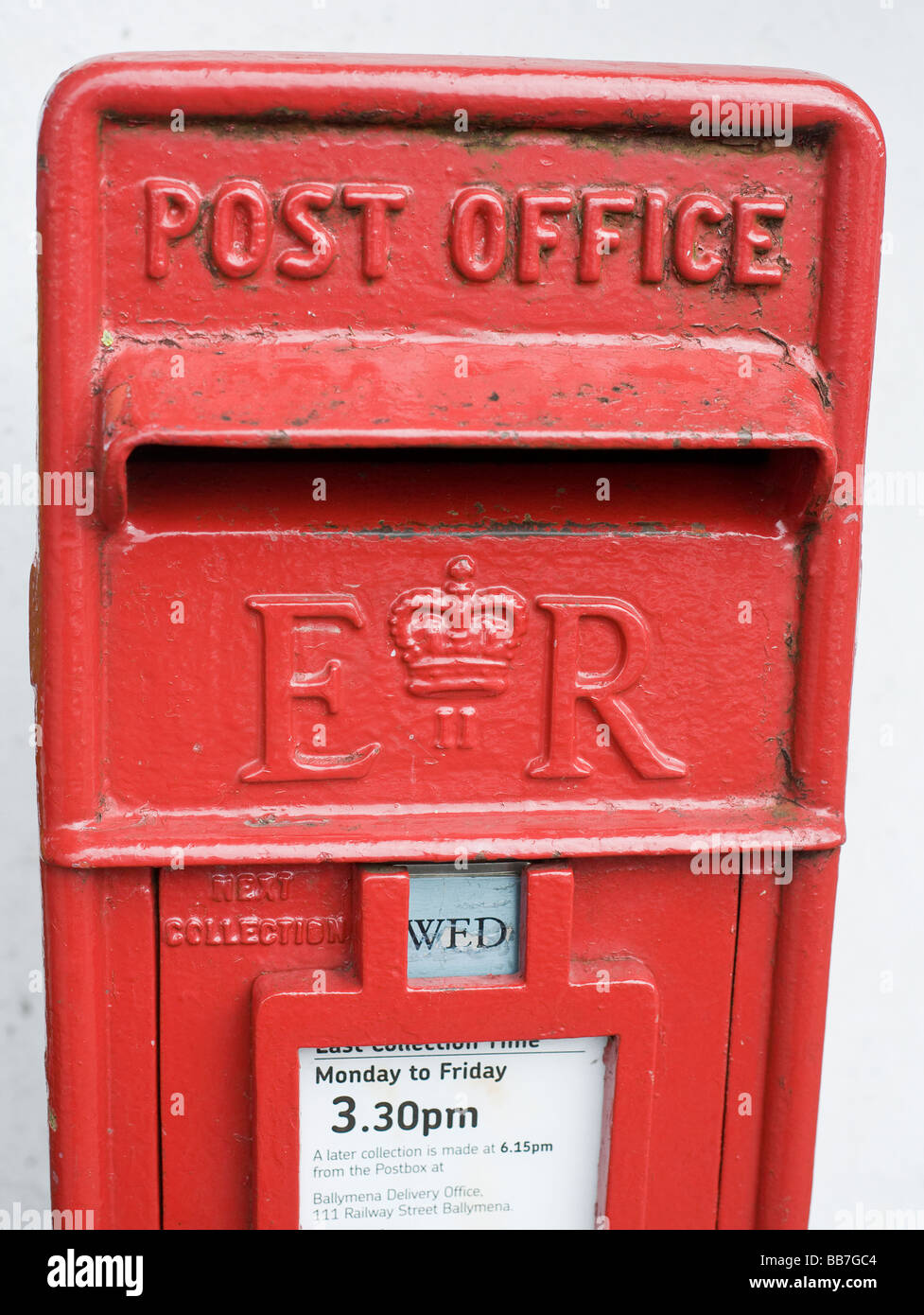 British Post Office Box. A red painted cast iron letter box in a wall