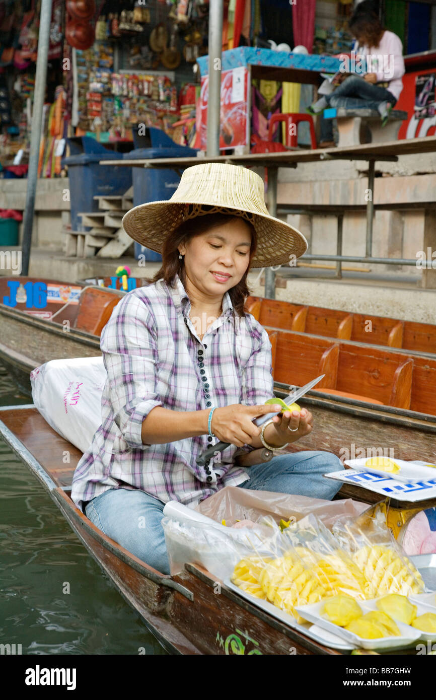 Selling food and souvenirs at the Damnoen Saduak floating market located about 62 miles outside of Bangkok Thailand Stock Photo