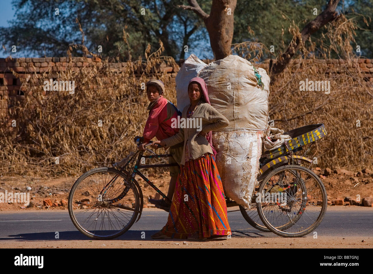 Indian pair of brothers and sisters transporting plastic garbage on a rickshaw, India, Asia Stock Photo